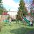 Portique en bois rond 4 agrès avec face à face et toboggan jacinthe Marron 4 - vertbaudet enfant 