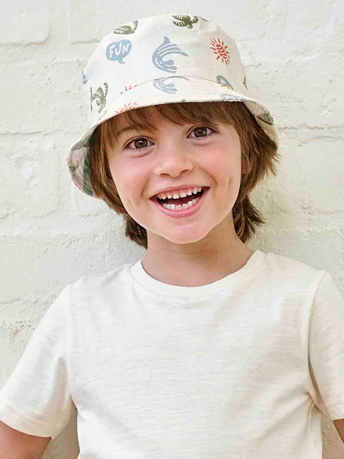 Lassig ® bob anti-uv bébé garçon réversible blanc avec imprimé palmier
